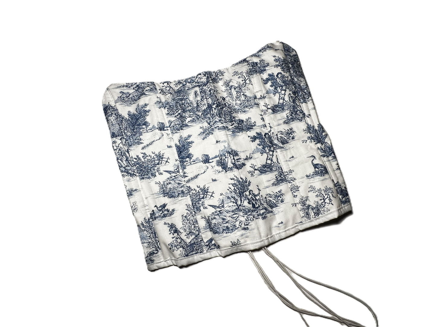 Trägerlose Corsage aus weißer Baumwolle mit blauem Toile-de-Jouy-Muster, verlängerter Schnitt und Rückenschnürung.